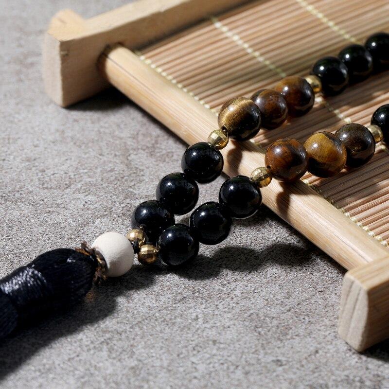 Collier de perles mala en bois avec pompon style macramé